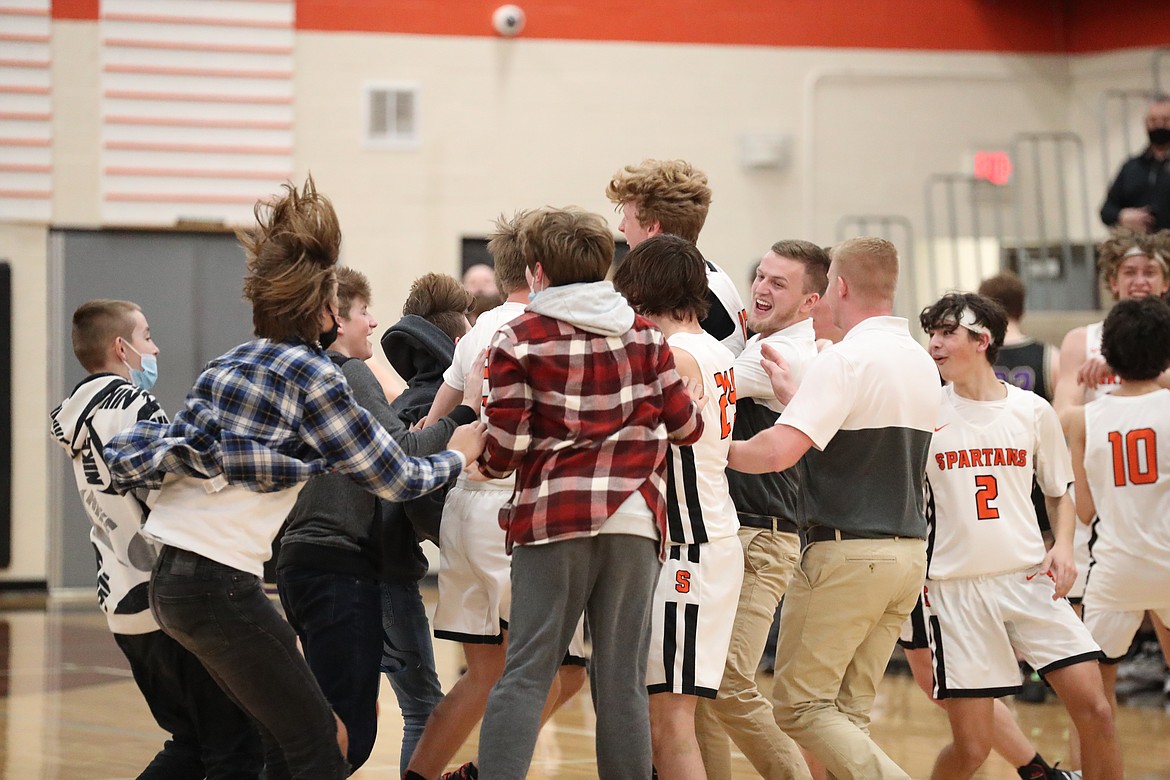 A group of students storm the court to celebrate with the team following Tuesday's win.