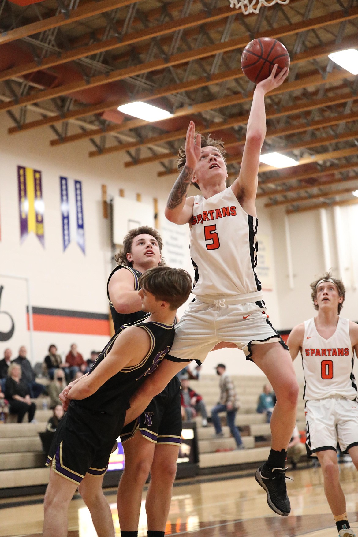 Trentyn Kreager fights through contact and converts a layup on Tuesday.