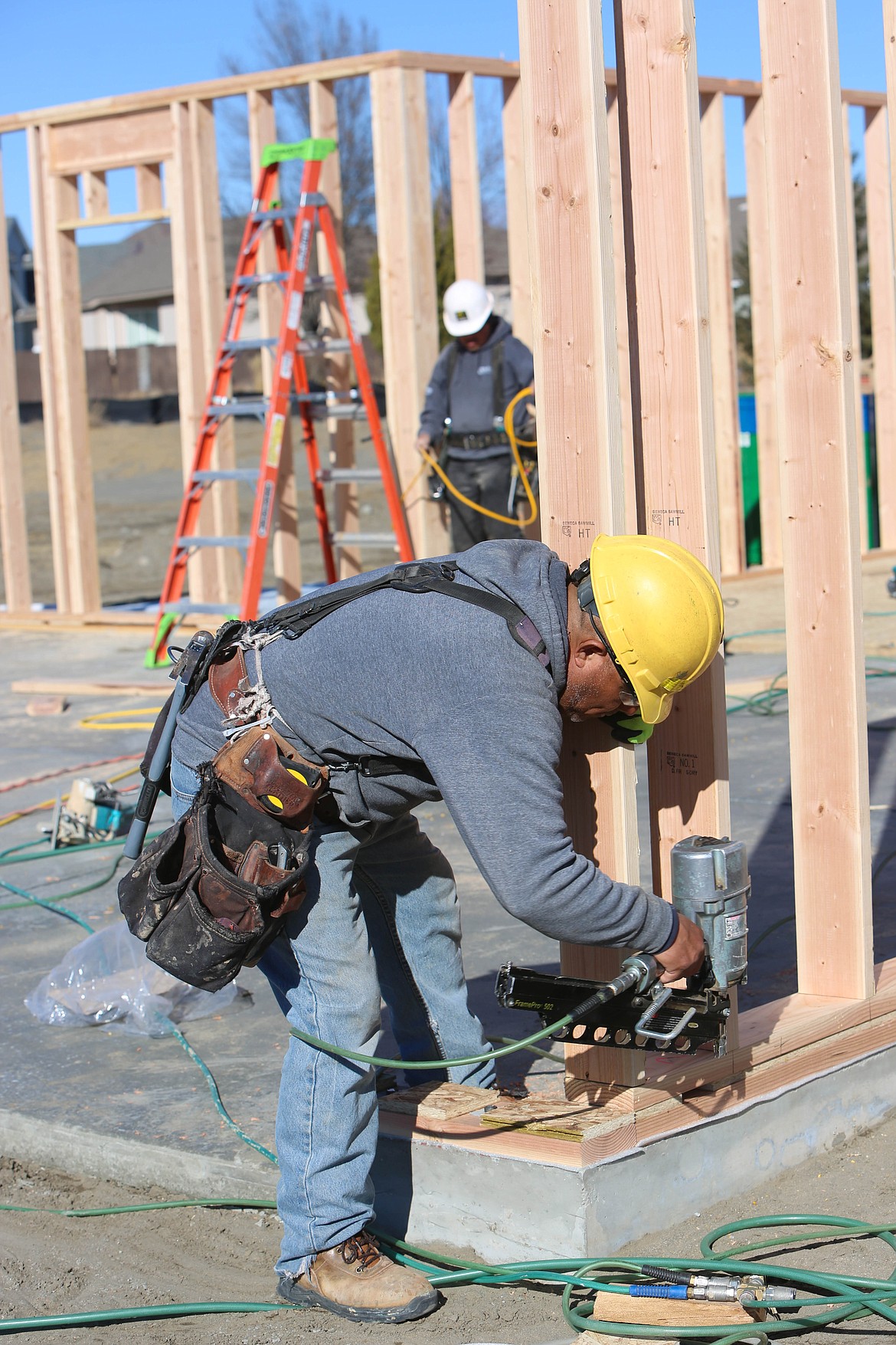 Ganaro Cedillo builds the frame of a Sagecrest home on North Hooper Drive.