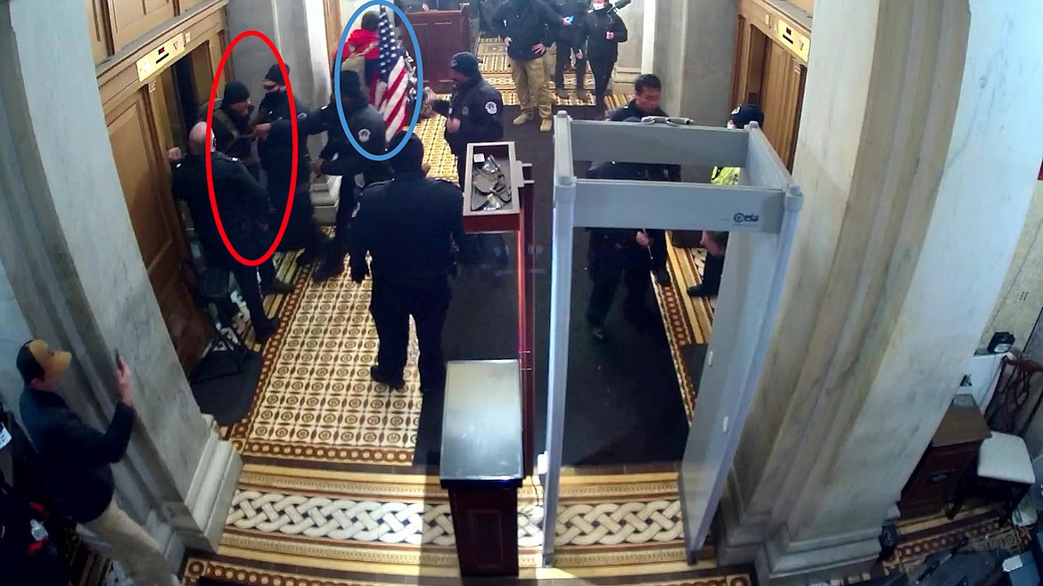 A still shot taken from surveillance video appears to show U.S. Capitol Police officers removing Michael Pope, circled in red, from an elevator. William Pope is allegedly pictured circled in blue.