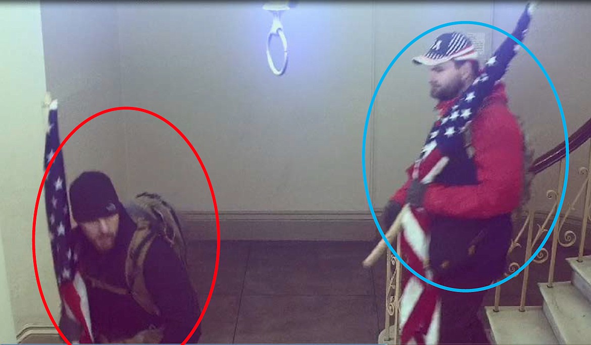 FBI agents say a still shot taken from a surveillance video that was timestamped at 2:20 p.m. on January 6, 2021, show William Pope, circled in blue, and Michael Pope, circled in red, coming down the stairs before exiting from the camera's view.