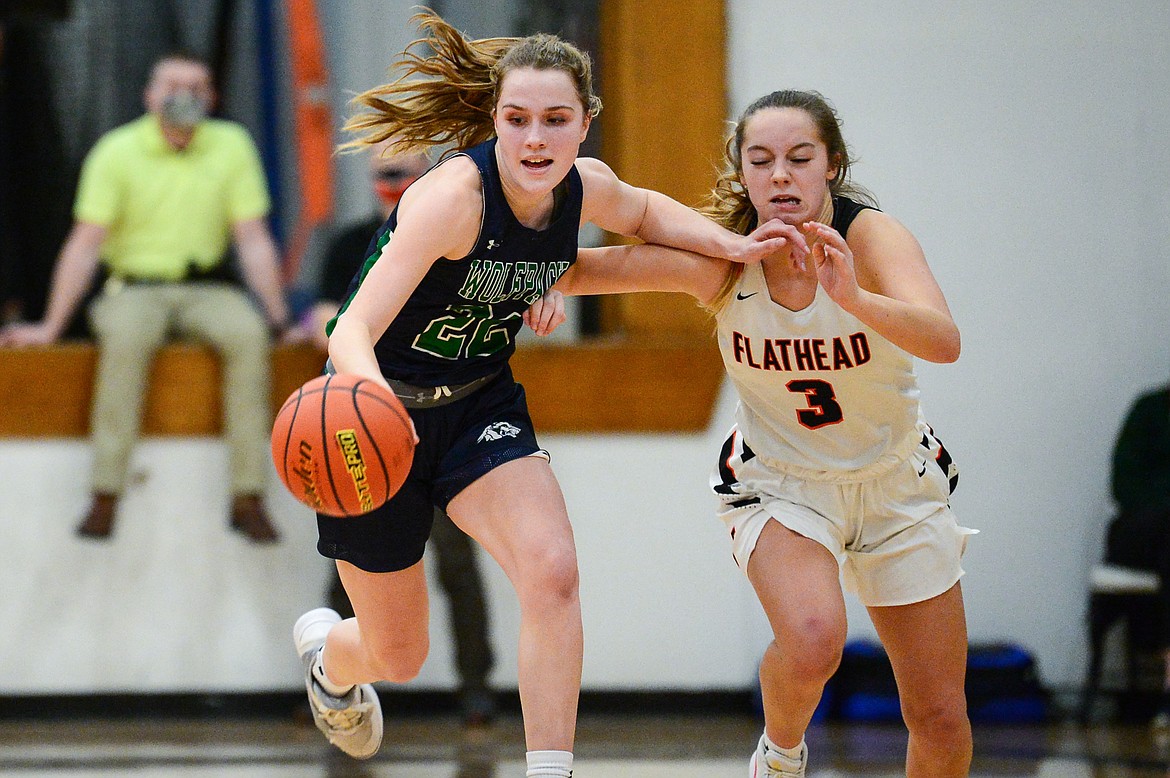 Glacier's Ellie Keller (22) picks up a loose ball in front of Flathead's Kuyra Siegel (3) at Flathead High School on Thursday. (Casey Kreider/Daily Inter Lake)