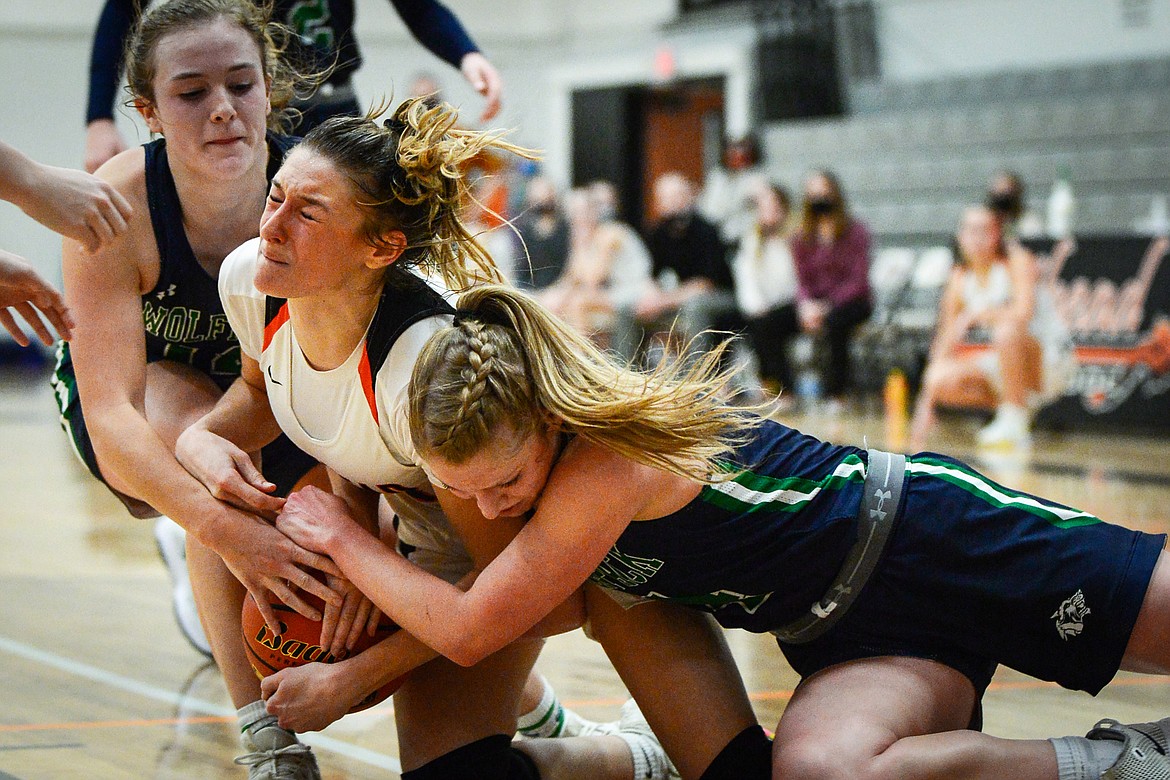 Flathead's Clare Converse (15) fights for the ball with Glacier's Kenzie Williams (12) and Kaylee Fritz (4) at Flathead High School on Thursday. (Casey Kreider/Daily Inter Lake)