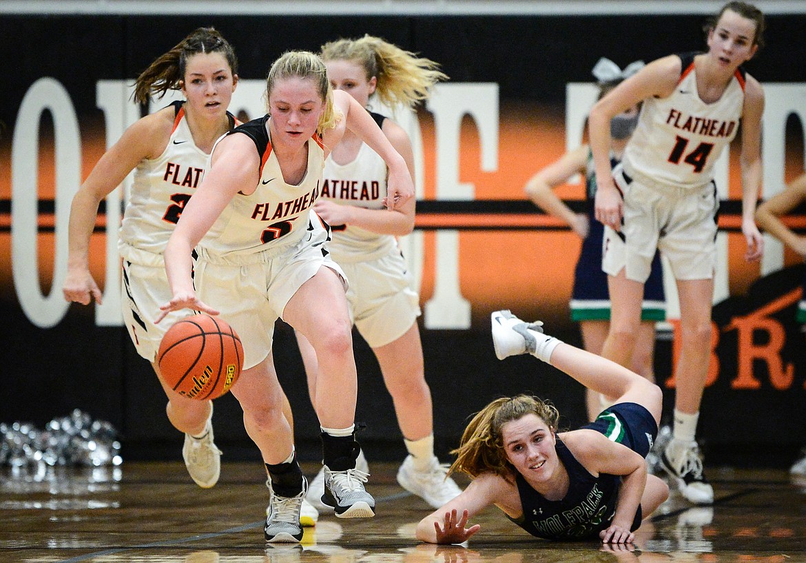 Flathead's Maddy Moy (5) scoops up a loose ball against Glacier at Flathead High School on Thursday. (Casey Kreider/Daily Inter Lake)