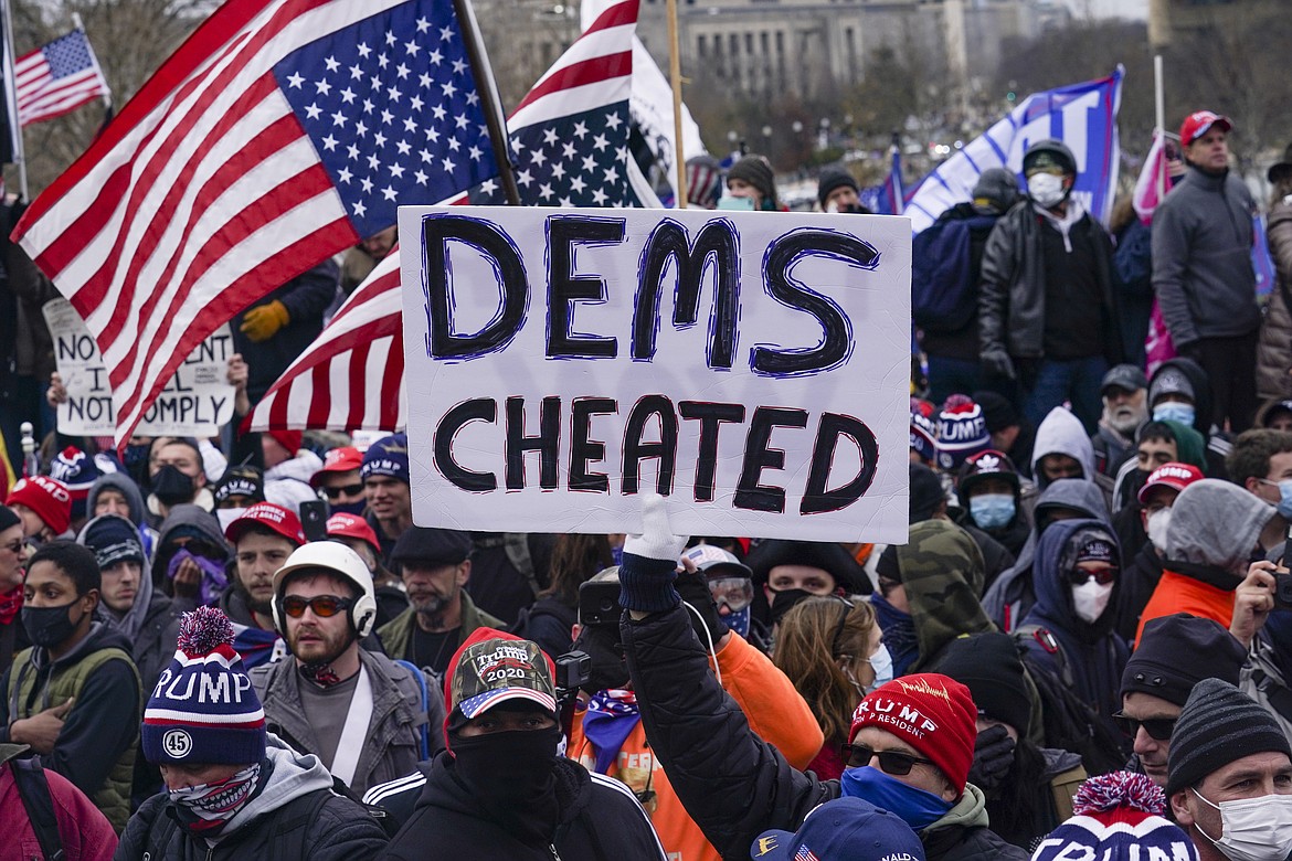 In this Wednesday, Jan. 6, 2021 file photo, Trump supporters gather outside the Capitol in Washington. A faction of local, county and state Republican officials across the country is pushing lies, misinformation and conspiracy theories online that echo those that helped inspire the violent Capitol insurrection, forcing the GOP into an internal reckoning. AP Photo/John Minchillo