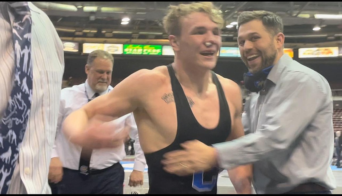 Photo courtesy JAN and JULIE SPEELMAN
Coeur d'Alene High junior Gunner Giulio celebrates with Viking assistant coach Tony Hook and coach Jeff Moffat, back, after winning the 170-pound title at the state 5A wrestling tournament in February at the Ford Idaho Center in Nampa.