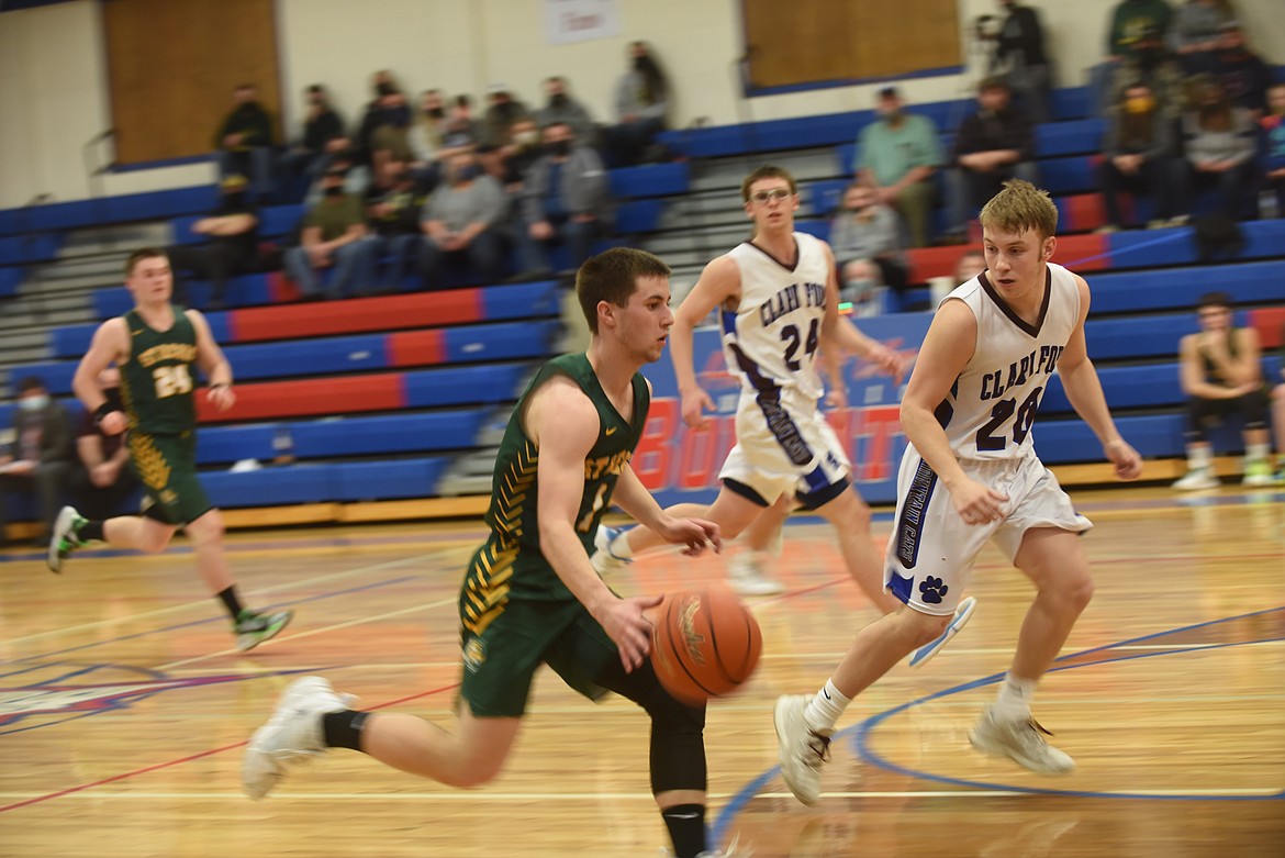 St. Regis' Caleb Ball races upcourt Feb. 20 against Clark Fork. (Scott Shindledecker/Mineral Independent)