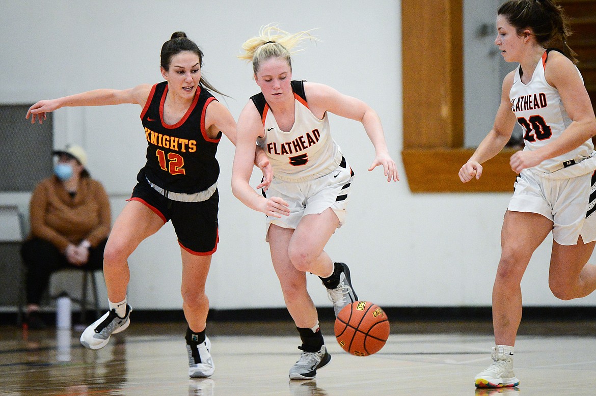 Flathead's Maddy Moy (5) battles Missoula Hellgate's Perry Paffhausen (12) for a loose ball at Flathead High School on Saturday. (Casey Kreider/Daily Inter Lake)