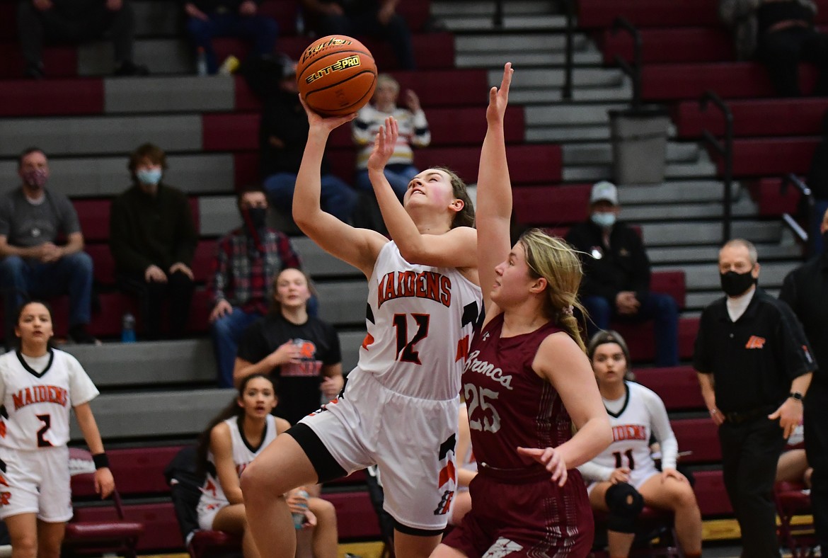 Ronan's Olivia Heiner goes to the hoop as Hamilton's Katelyn Dickamore defends Friday in Butte. (Teresa Byrd/Hungry Horse News)