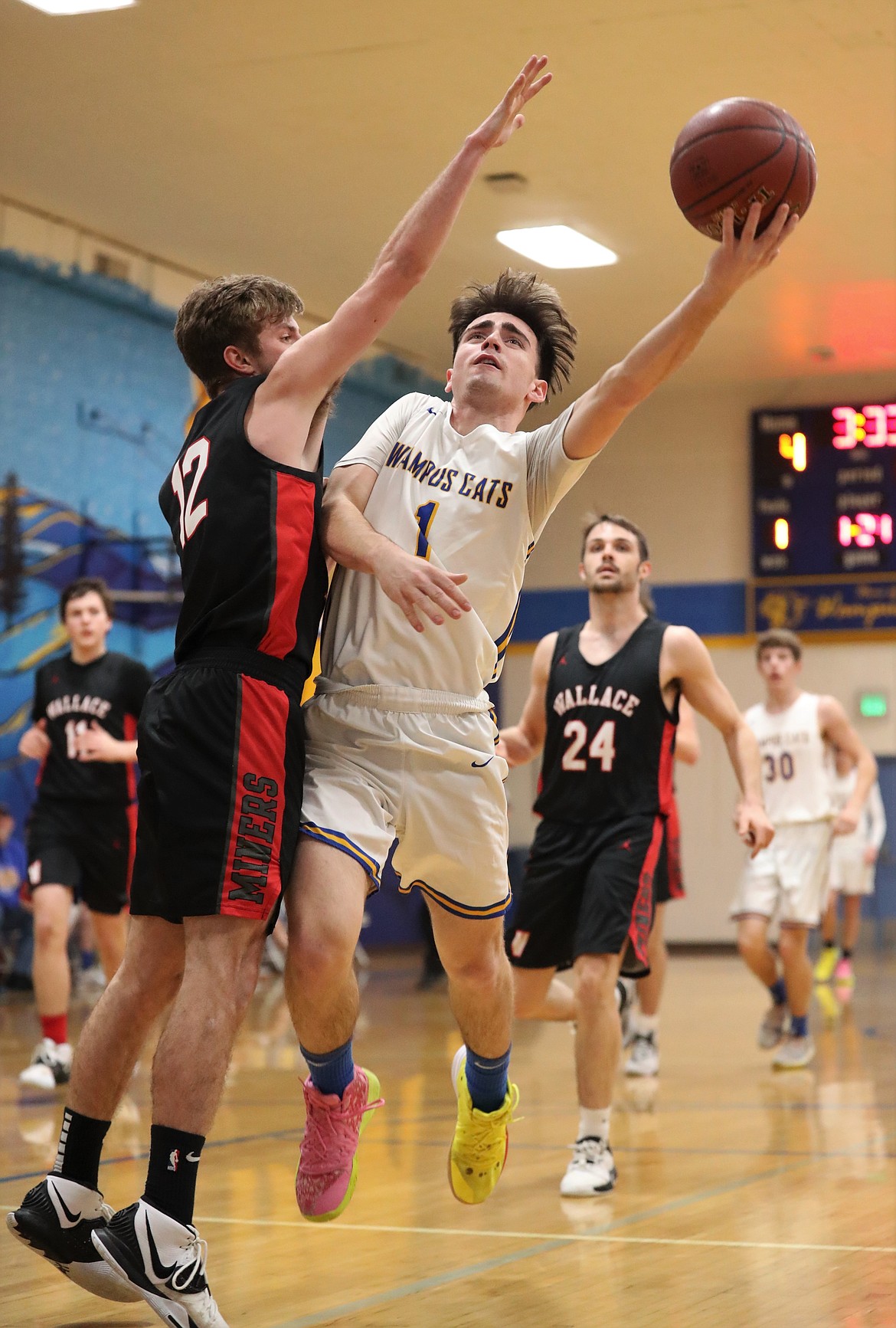 Senior Cameron Garcia fights through contact and attempts a layup during a home game against Wallace on Feb. 1.