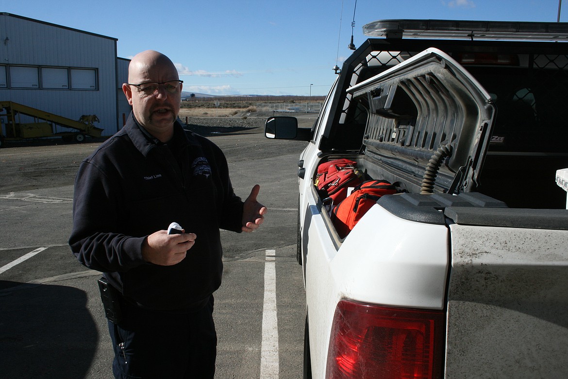 Grant County Fire District chief Eric Linn explains the equipment setup of district trucks.