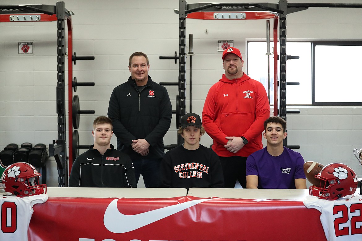 Sandpoint's Tag Benefield, Max Thielbahr and Elijah Larson celebrated their commitments to play collegiately on Tuesday morning. Tag received a preferred walk-on offer to the University of Idaho football team, Max is heading to Occidental College for baseball and Elijah will be playing football at Carroll College this fall. Pictured in the front row (from left): Tag Benefield, Max Thielbahr and Elijah Larson. Back row: Sandpoint offensive coordinator Jeremy Thielbahr (left) and Sandpoint head football coach Ryan Knowles.