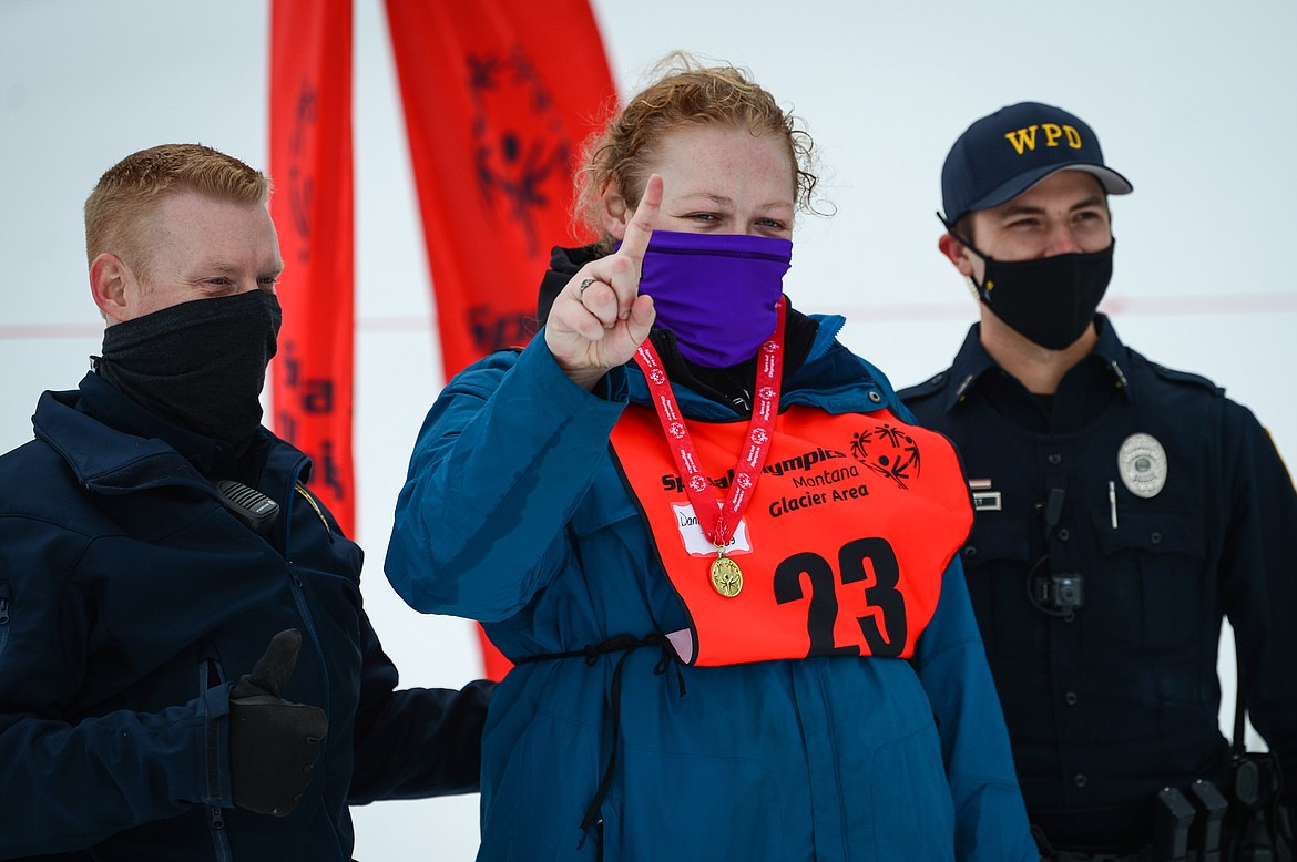 Dani Dorman, left, with the Flathead Industries team, celebrates after receiving her medal in the Giant Slalom event at the Special Olympics Montana Winter Games at Whitefish Mountain Resort on Tuesday. With Dorman are officer Jason Parce of the Kalispell Police Department and officer Trey Nasset with the Whitefish Police Department. Parce and Nasset were distributing medals at the awards ceremony. (Casey Kreider/Daily Inter Lake)
