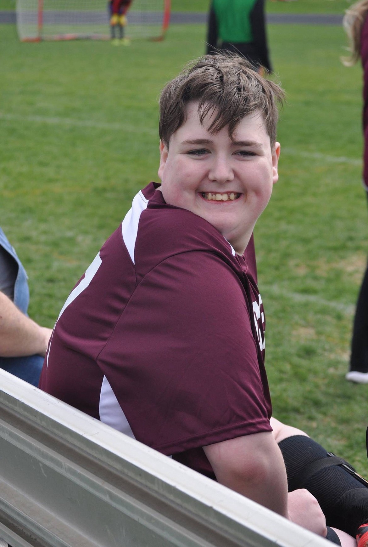 Moses Lake High School's Adam Carpenter smiles from the bench during a unified soccer match in 2018.