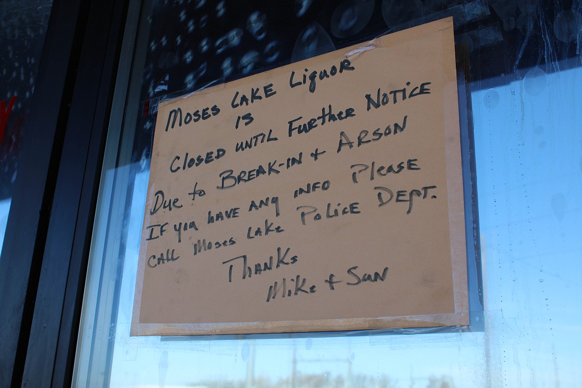A sign posted on the door of Moses Lake Liquor & Wine