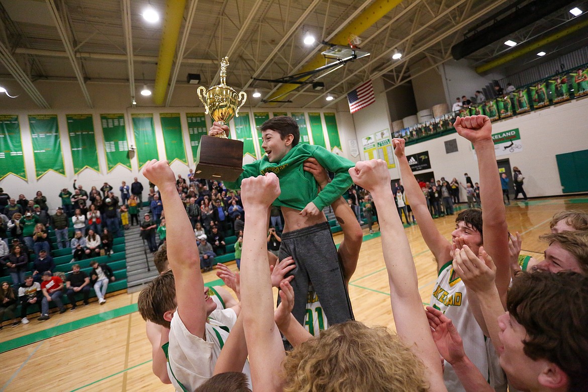 JASON DUCHOW PHOTOGRAPHY
Lakeland players hoist Cameron Ryan, son of assistant coach Bill Ryan and brother of Lakeland volleyball and basketball star Katy Ryan, after winning the 4A Region 1 boys basketball championship last Saturday in Rathdrum.