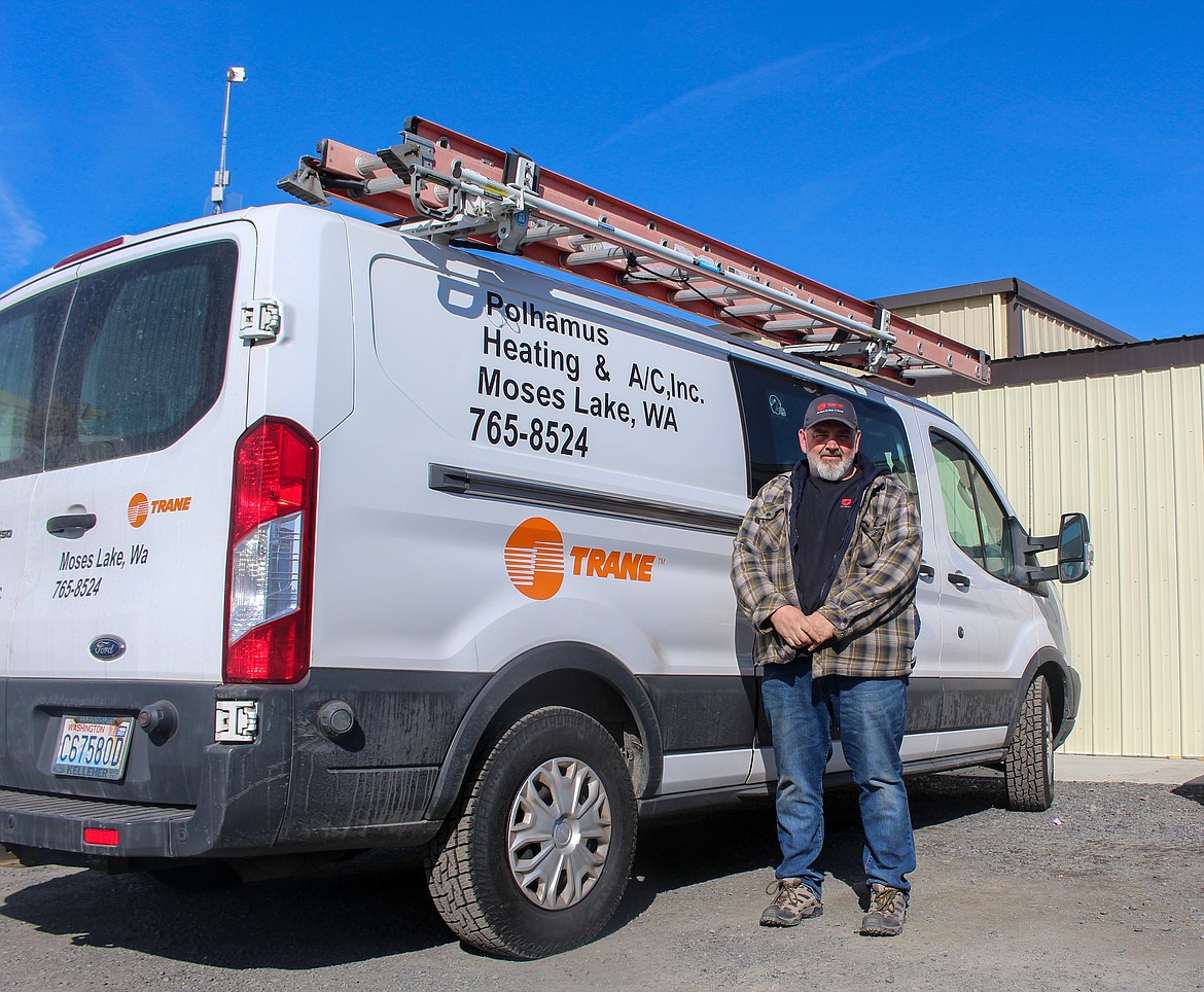 Polhamus service manager Dave Carlson stands beside the company service truck outside the office on Bell Road Northeast in Moses Lake on Wednesday afternoon.