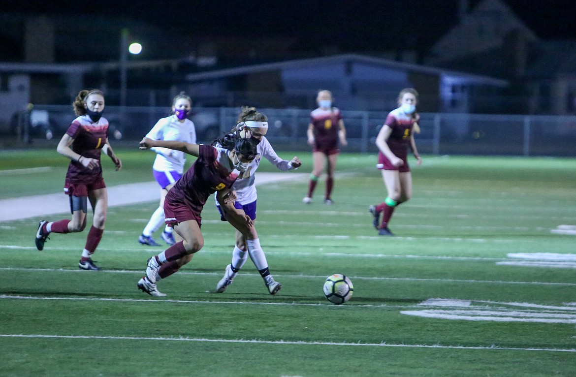 Moses Lake's Risa Nishida vies with the Wenatchee defender as she pursues the ball in the second half of her final home game with the Chiefs on Tuesday night at Lions Field.
