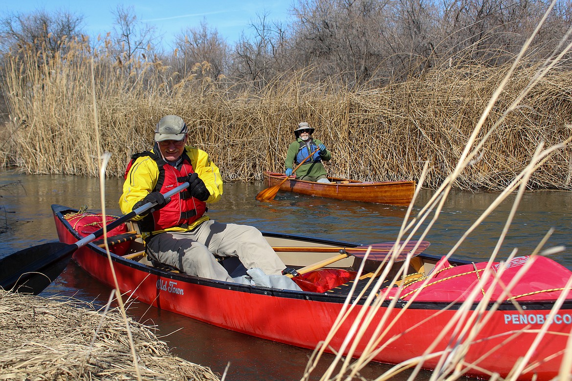 Left to right, Dana Ertel and John Brodeur drop their canoes in the water deep inside the Potholes Wildlife Area with hopes of coming out near Potholes State Park on Wednesday afternoon.