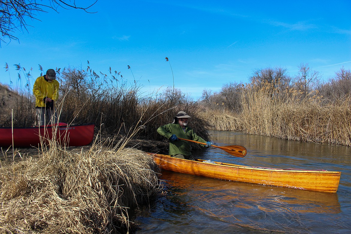 Left to right, Dana Ertel and John Brodeur get their canoes into the waterway on Wednesday afternoon as they get set to snake their way toward Potholes State Park.