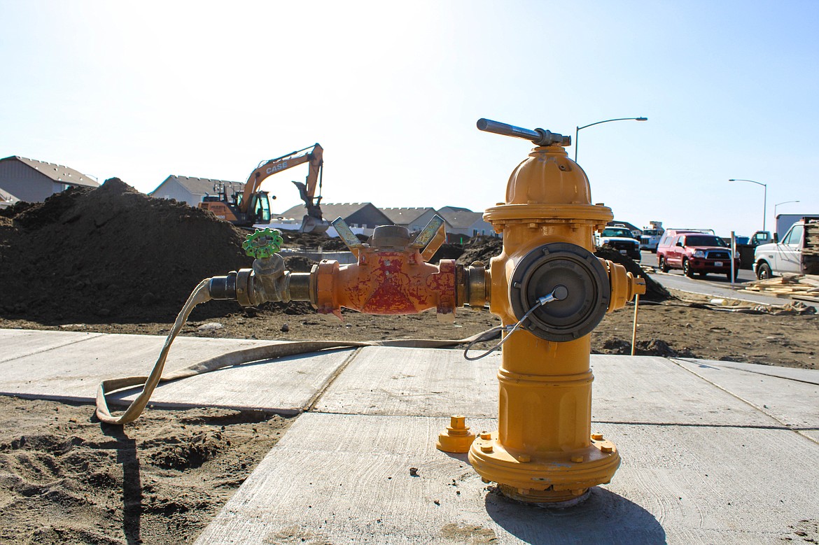 Hayden Homes works to install the waterline on West Heaverlo Drive in Moses Lake.