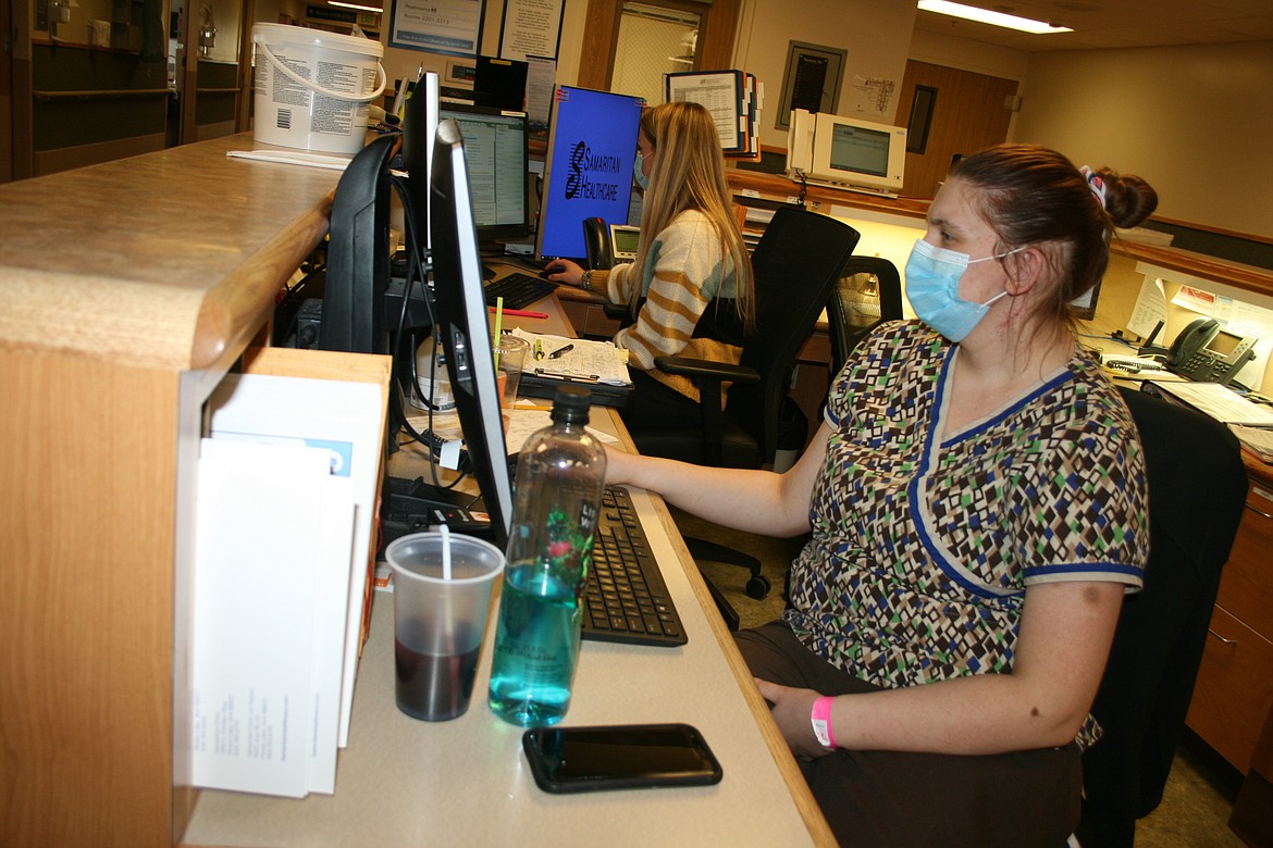 Certified nurse assistant Amanda Watkins (front) and registered nurse Holly Perry (back) enter data in a nurse's station at Samaritan Hospital. Samaritan officials have completed a second study to determine the feasibility of paying back loans to build a new hospital.