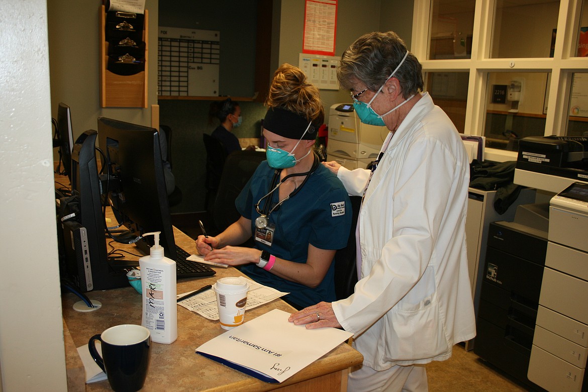 Nursing student Shalon Gough (left) consults with nursing instructor Katherine Christian (right) in a nurse's station at Samaritan Hospital. A second study on Samaritan's ability to pay back loans to build a new hospital has been completed.