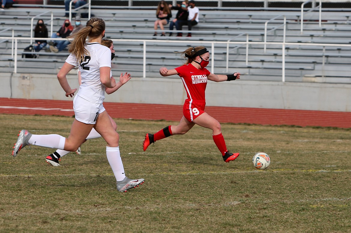 Senior Gracie Sorenson fires a ball in toward the middle of the field in the first half of the Huskies' 2-1 defeat against North Central High School at Othello High School on Thursday afternoon.