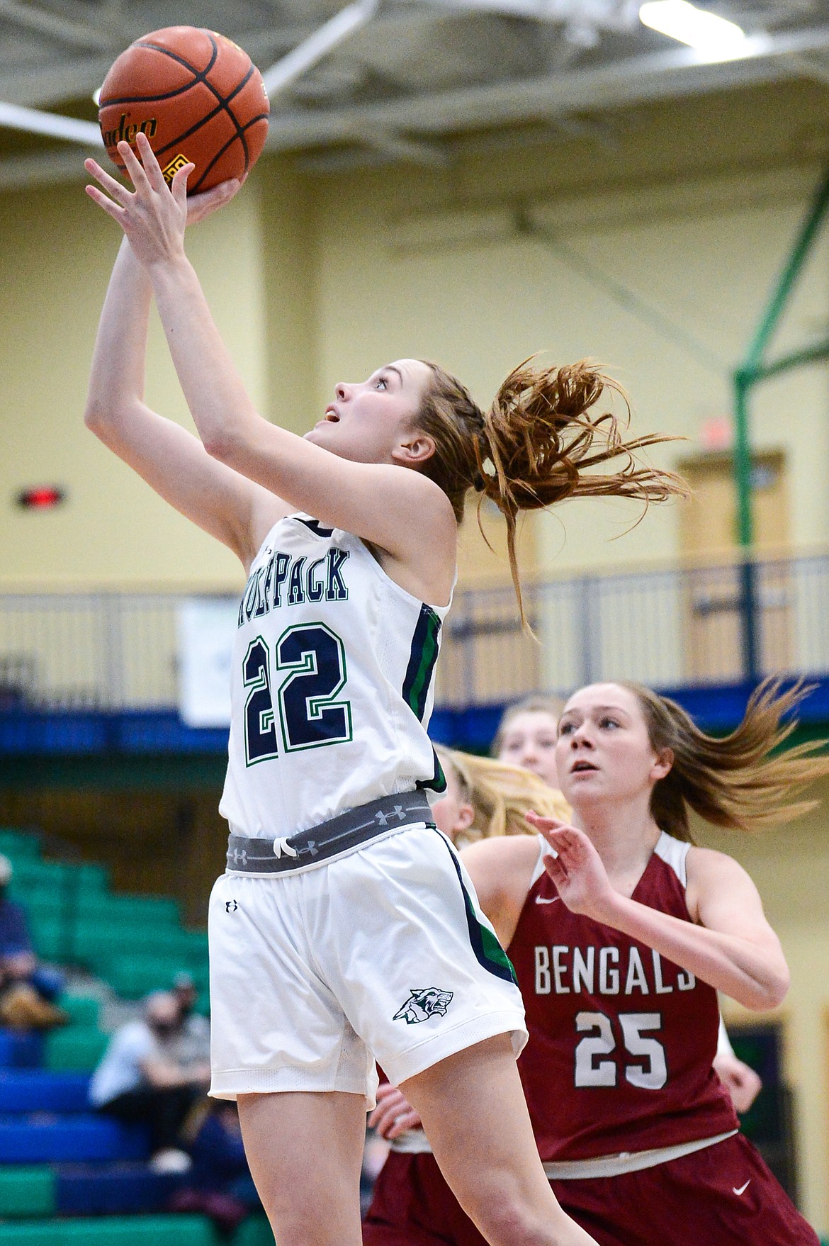 Glacier's Ellie Keller (22) gets to the basket past Helena's Elizabeth Heuiser (25) in the first half of a state AA play-in game at Glacier High School on Thursday. (Casey Kreider/Daily Inter Lake)
