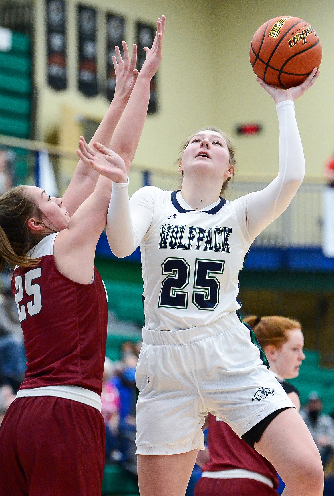 Glacier's Emma Anderson (25) shoots over Helena's Elizabeth Heuiser (25) in the first half of a state AA play-in game at Glacier High School on Thursday. (Casey Kreider/Daily Inter Lake)