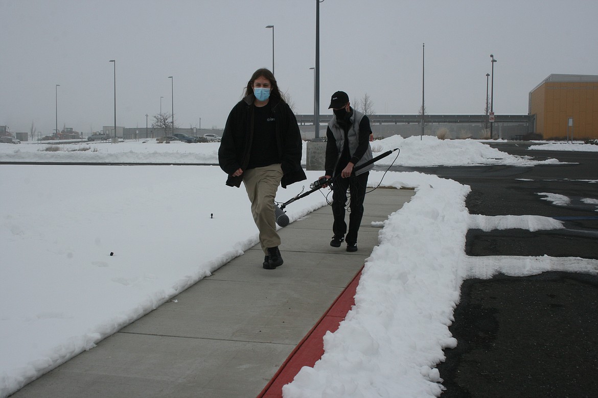 Austin Peterson (front) makes a run for it to produce just the right sound effect for his film project for the digital arts an filmmaking class at Columbia Basin Technical Skills Center. Classmate Noah Carpenter (back) carries the sound recording equipment.