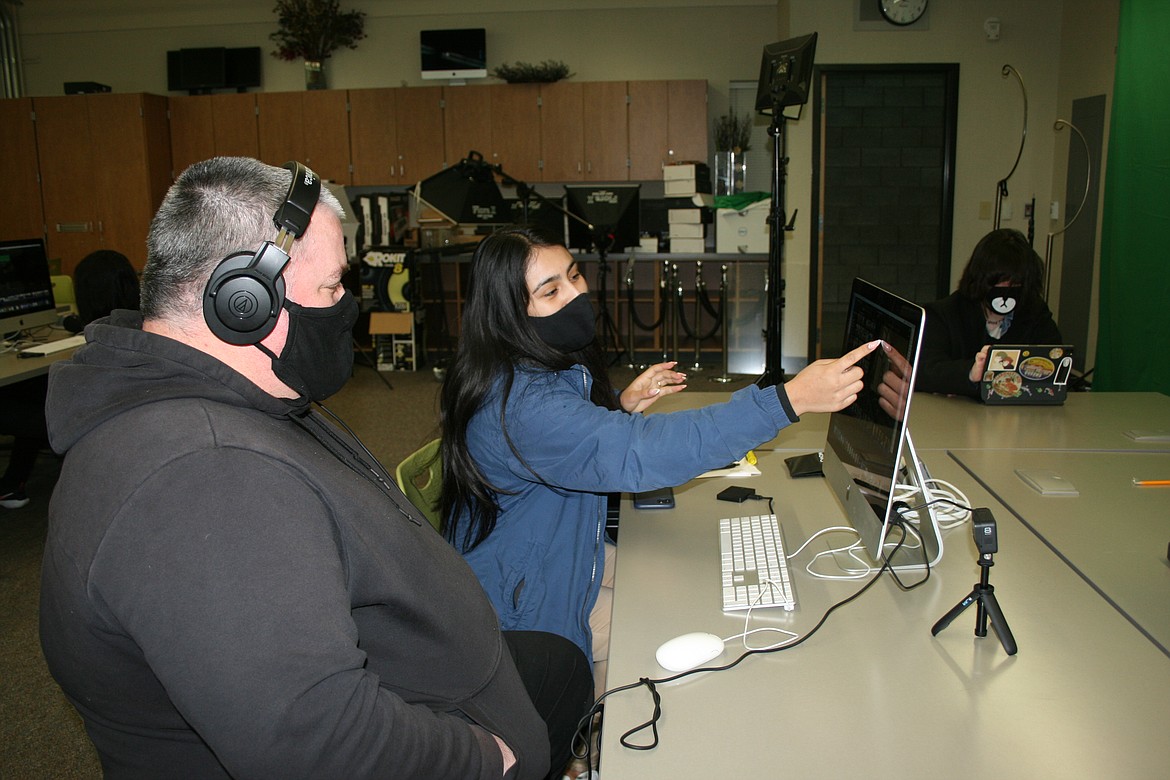 Aaliyah Cervantes (back) points out a scene that needs more editing to digital arts and filmmaking instructor Joe LaRosee (front). The Columbia Basin Technical Skills Center class teaches design and production skills.