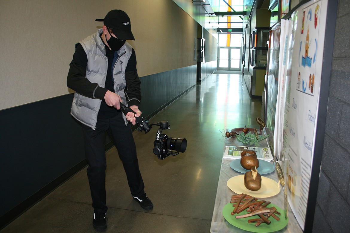 Noah Carpenter uses a panning tool to get a steady picture of a metal baked potato sculpture during the digital arts and filmmaking class at Columbia Basin Technical Skills Center.