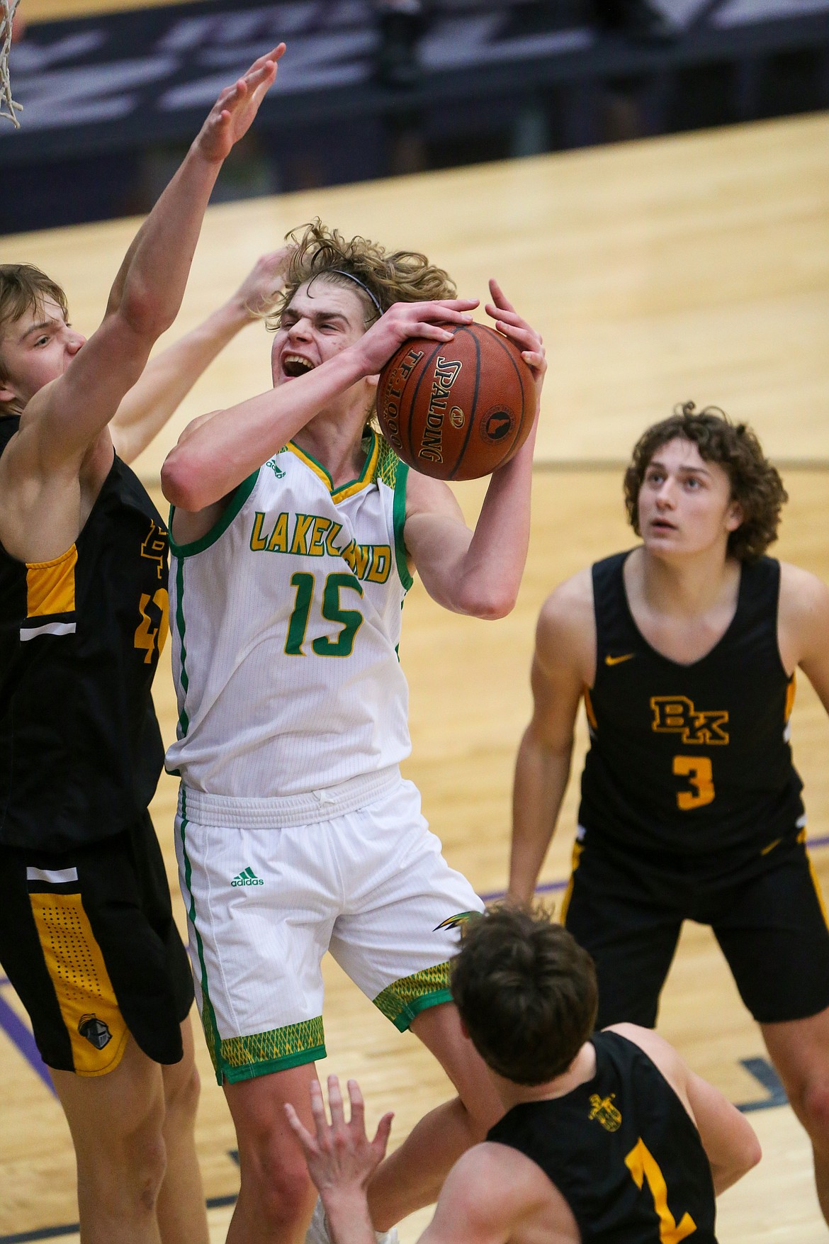 JASON DUCHOW PHOTOGRAPHY
Noah Haaland (15) of Lakeland goes up for a shot as Blake Hawthorne, left of Bishop Kelly defends and Keegan Croteau (3) looks on Thursday in a first-round game at the state 4A boys basketball tournament at Rocky Mountain High in Meridian.