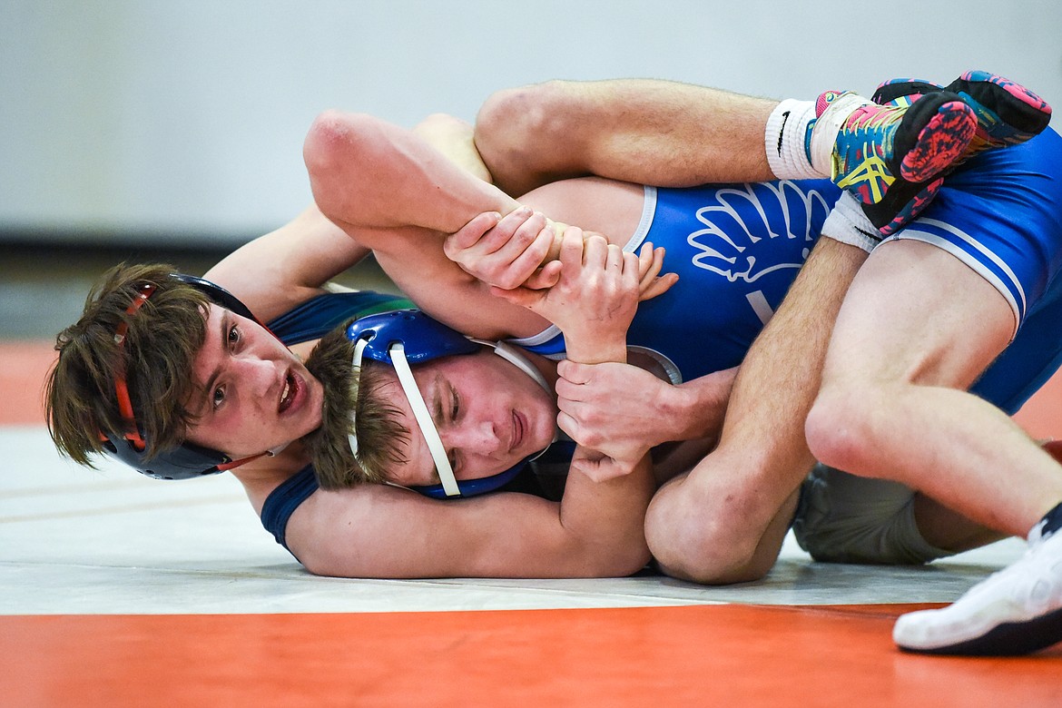 Glacier's Kaleb Shine wrestles Billings Skyview's Talen Barrington at 132 lbs. during the State AA wrestling championships at Flathead High School on Friday. (Casey Kreider/Daily Inter Lake)