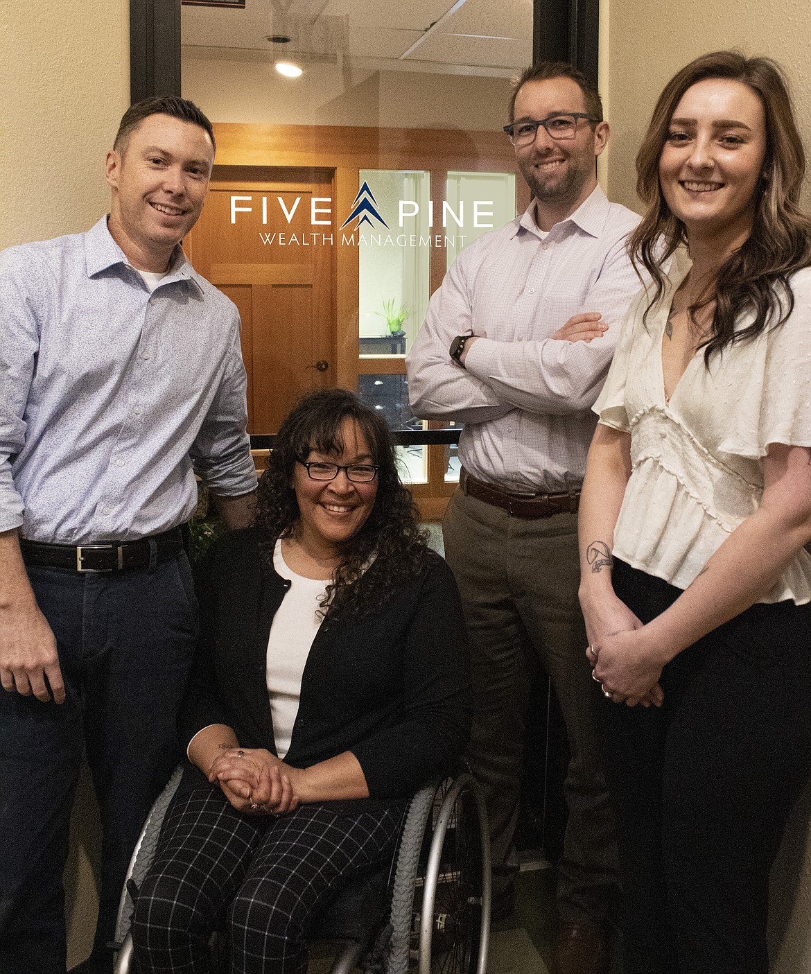 Courtesy photo
Five Pine Wealth Management employees, from left, Jeremy Morris, Sherrie Petersen, Ben Holzhauser and Cheyanne Ross, pose in their new office on Sherman Avenue (located above the Coeur d'Alene Resort Shops).