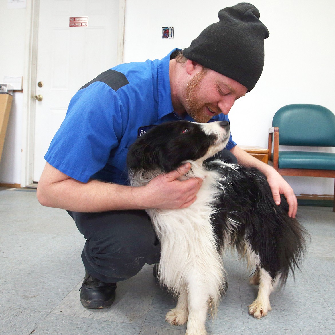 Brandon George shared a moment with his border collie, Bubbers, at CDA Import Auto Repair the day after Bubbers was attacked.