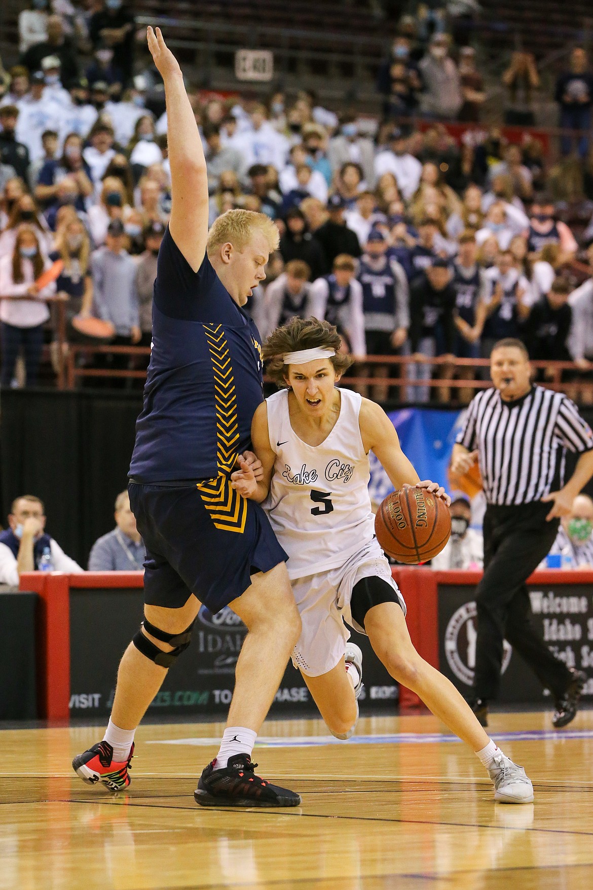 JASON DUCHOW PHOTOGRAPHY
Jack Kiesbuy, right, of Lake City tries to drive around Brody Rowbury of Meridian in the state 5A championship game Saturday night at the Ford Idaho Center in Nampa.