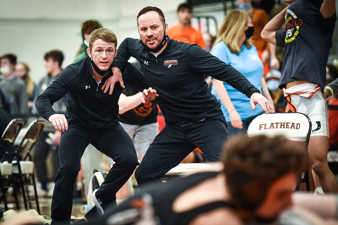 Flathead assistant coaches Justin Whitman, left, and Dallas Stuker watch as Braves wrestler Asher Kemppainen scores on a reversal to win his match over Belgrade's Carter Schmidt at 132 lbs. at the State AA wrestling tournament at Flathead High School on Saturday. (Casey Kreider/Daily Inter Lake)