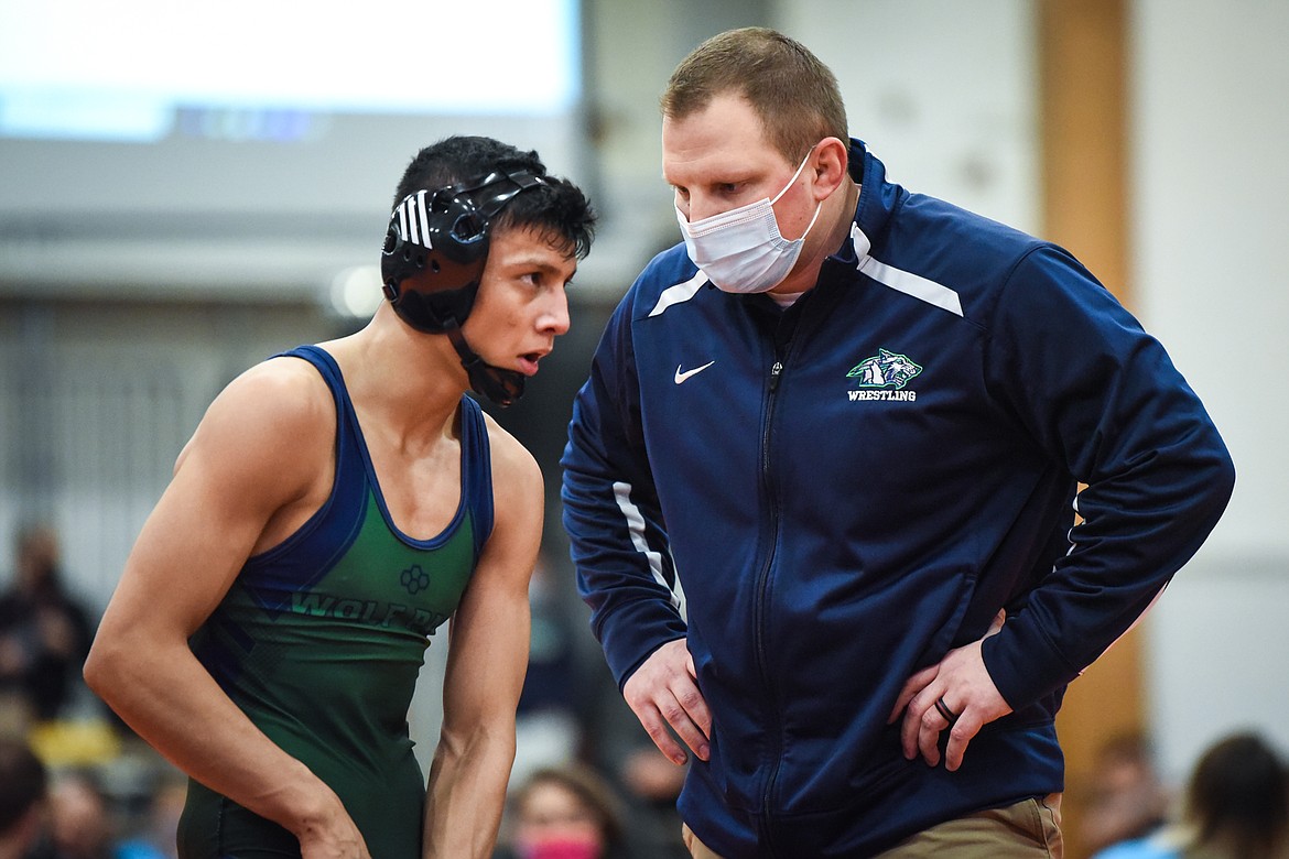 Glacier head coach Ross Dankers speaks to Teegan Vasquez during a pause in his 120 lb. match with Billings Skyview's Hunter Ketchum at the State AA wrestling tournament at Flathead High School on Saturday. (Casey Kreider/Daily Inter Lake)