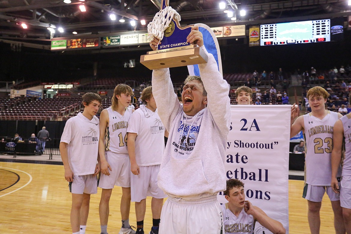 JASON DUCHOW PHOTOGRAPHY
St. Maries senior Carson Wicks shows off the state 2A boys basketball championship trophy to a cheering Lumberjack fans after a 51-50 win over Ambrose of Meridian on Saturday morning at the Ford Idaho Center in Nampa. It is the program's first title since 1960.