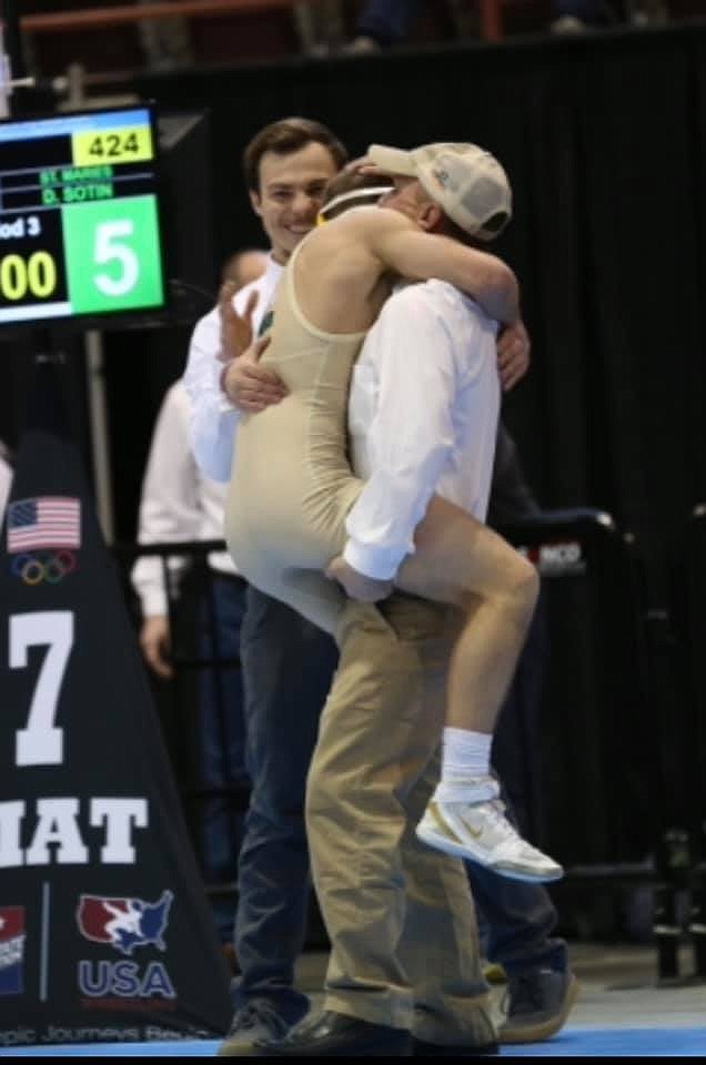 Courtesy photo
St. Maries High senior Dylan Sotin jumps into the arms of Lumberjack coach Dennis Humphrey following his win in the 120-pound championship match in the state 2A tournament on Feb. 27 at the Ford Idaho Center. It was Sotin's first title.