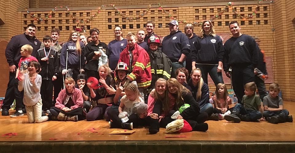 Firefighters for Kids poses with foster kids in Spokane Valley in December, 2016.