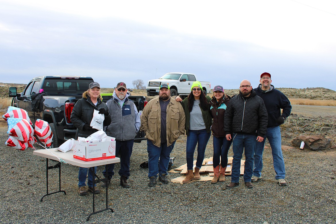 Left to right, Quincy Youth Fishing Day hosts Julie Putnam, Gene Rosenburger, Ryan Peterson, Catalina Blancas, Robbi Rublo, Fernando Avalos and Galen Golay hand out goodie bags and fishing kits first thing Saturday morning.