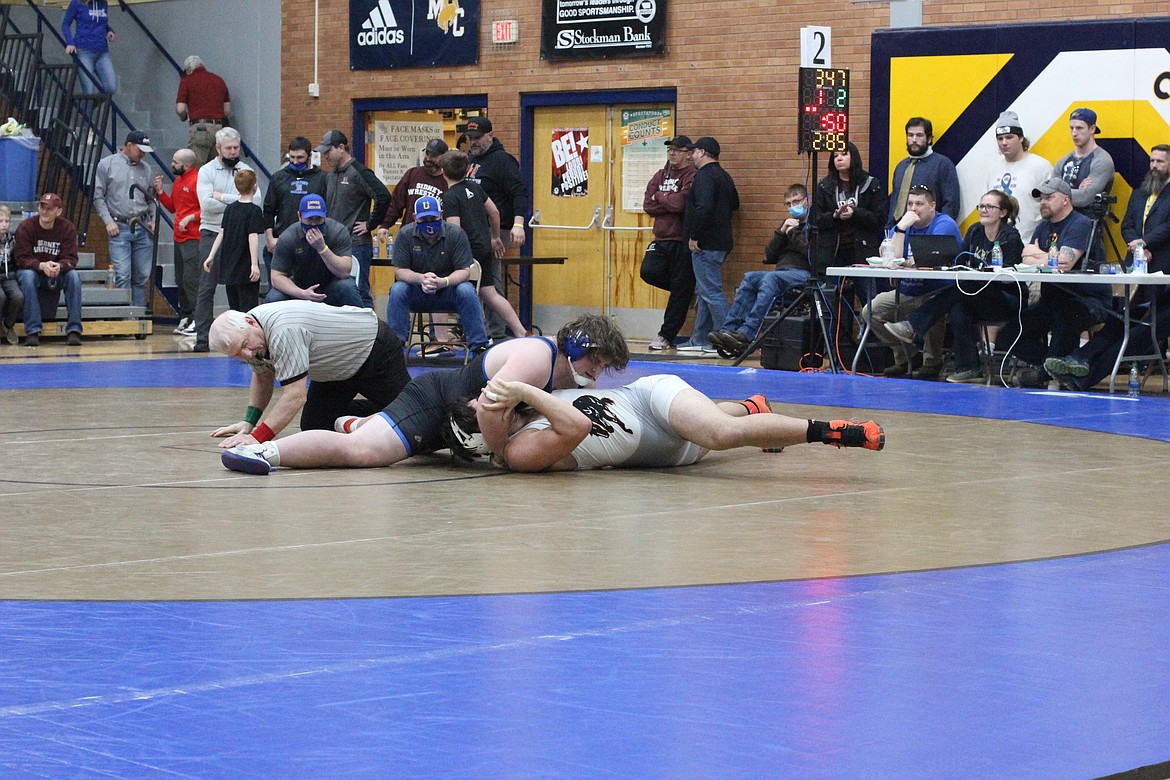 Greenchain's heavyweight wrestler Aydan Williamson pins Frenchtown's Phillip Herald during the class A state wrestling tournament. (Courtesy photo)