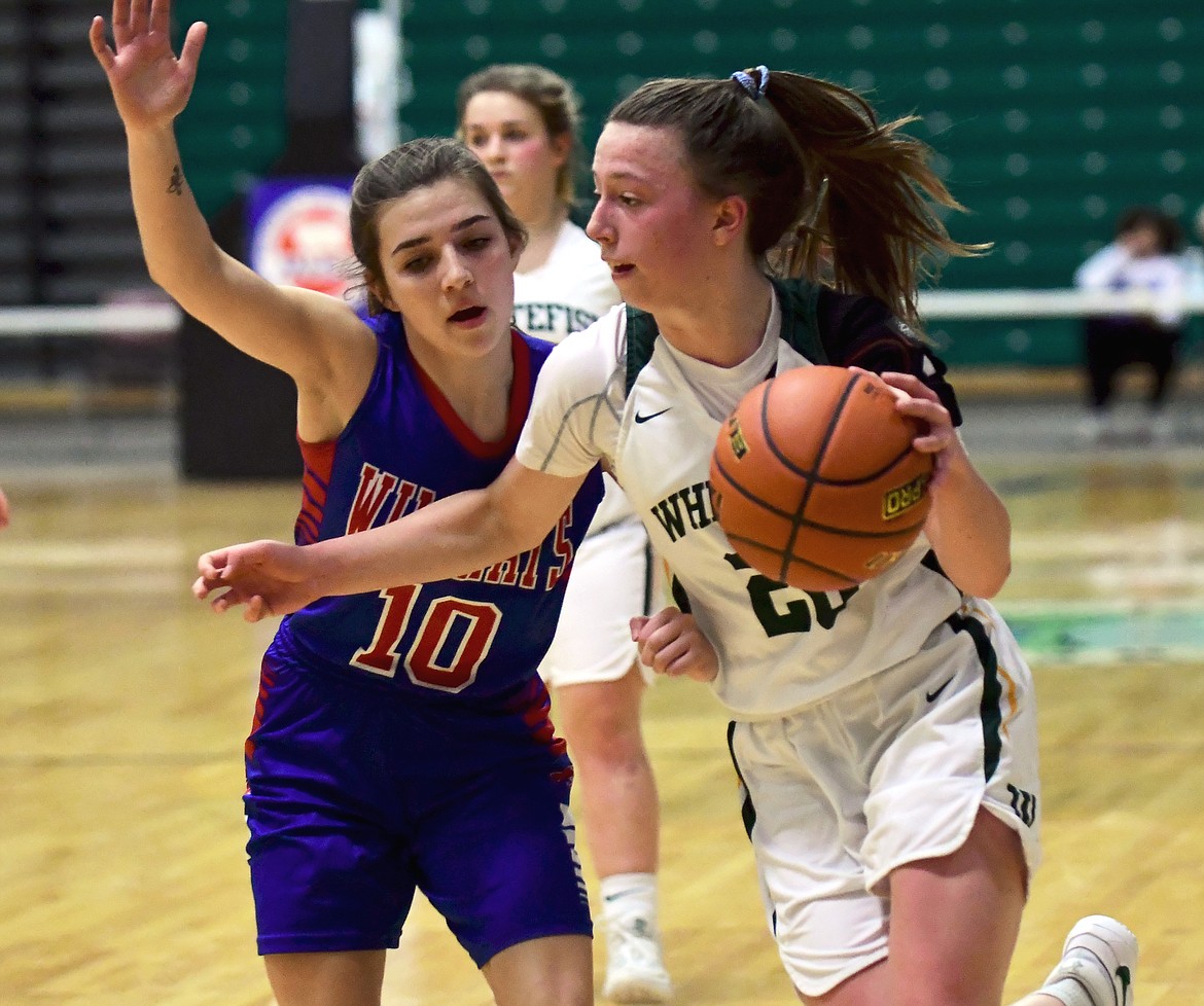 Whitefish's Mikenna Ells tries to dribble around Columbia Falls' Alexis Green during a loser-out game at the State Class A Girls Basketball Tournament on Friday. (Teresa Byrd/Hungry Horse News)