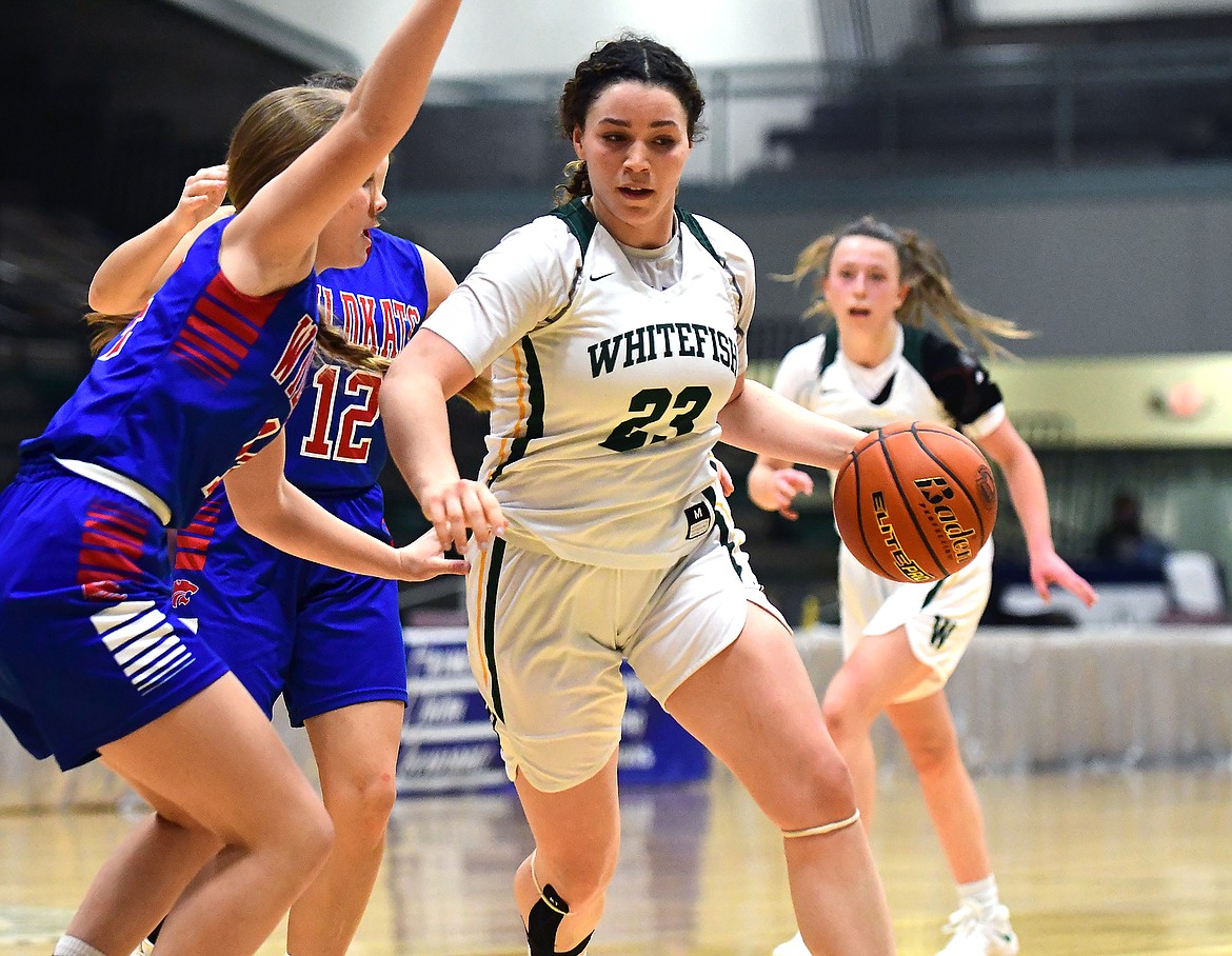 Gracie Smyley moves past defenders in a game against Columbia Falls at the state A
tournament in Great Falls on Friday. (Teresa Byrd/Hungry Horse News)