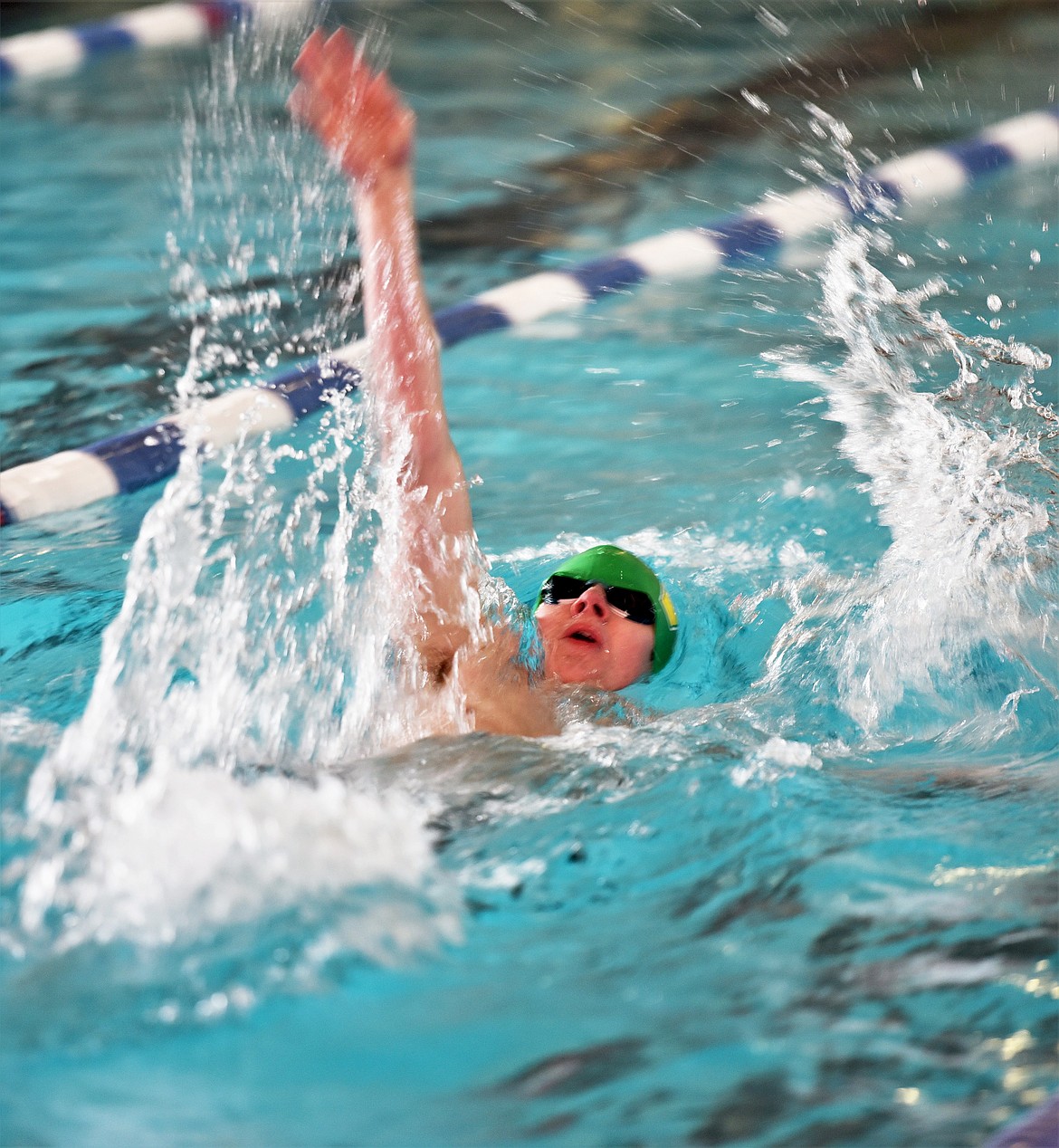 Bulldog Aaron Dicks swims in the 100 Yard Backstroke race at the Montana Class A State swim meet on Saturday, March 6 in Polson. (Scot Heisel/Lake County Leader)