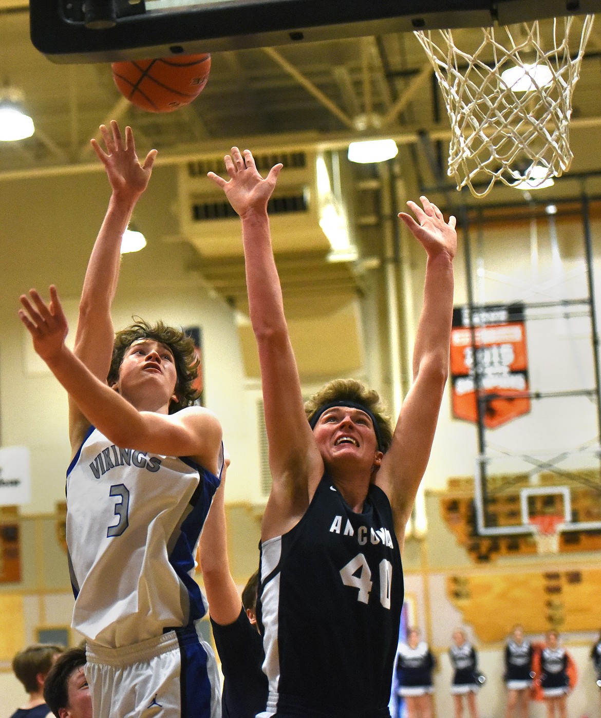 Bigfork's Isak Epperly puts in a shot over Anaconda's Landon Hurley during play at the Western B Divisional Basketball Tournament in Eureka Thursday. (Jeremy Weber/Daily Inter Lake)