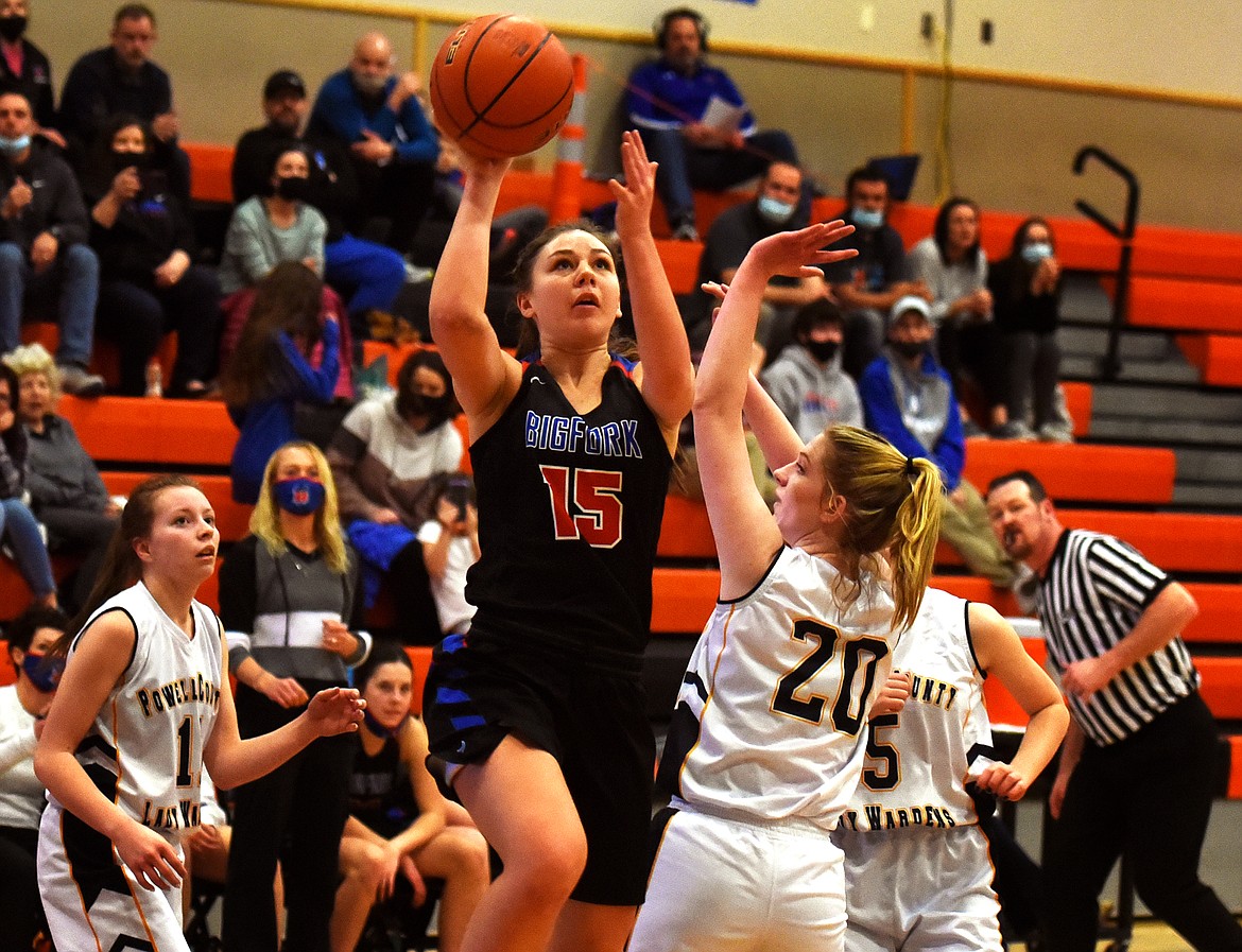 Bigfork's Madison Chappuis goes up for a shot over Deer Lodge defender Emma Johnson in the fourth quarter of the Valkyries 51-14 win at the Western B Divisional Basketball Tournament Thursday. (Jeremy Weber/Daily Inter Lake)